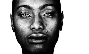 face of a Black woman with a tear down the left side of her face